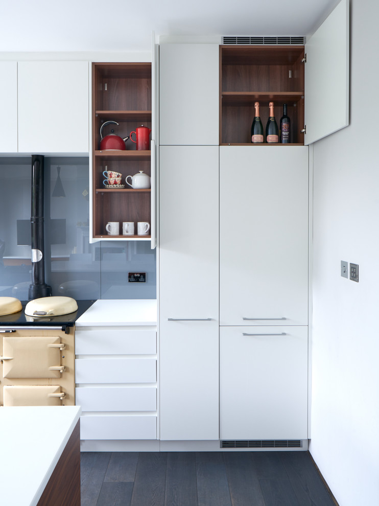 Design ideas for a large contemporary open plan kitchen in London with flat-panel cabinets, white cabinets, grey splashback, glass sheet splashback and an island.