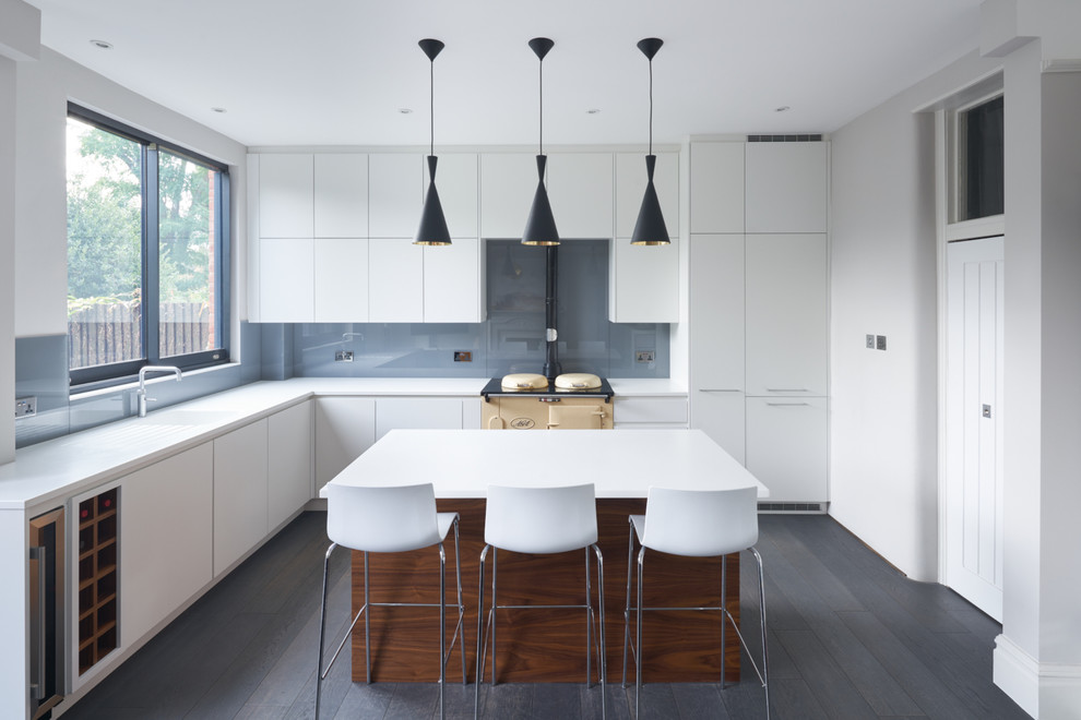 Exempel på ett stort modernt kök med öppen planlösning, med en integrerad diskho, släta luckor, vita skåp, grått stänkskydd, glaspanel som stänkskydd, mörkt trägolv och en köksö