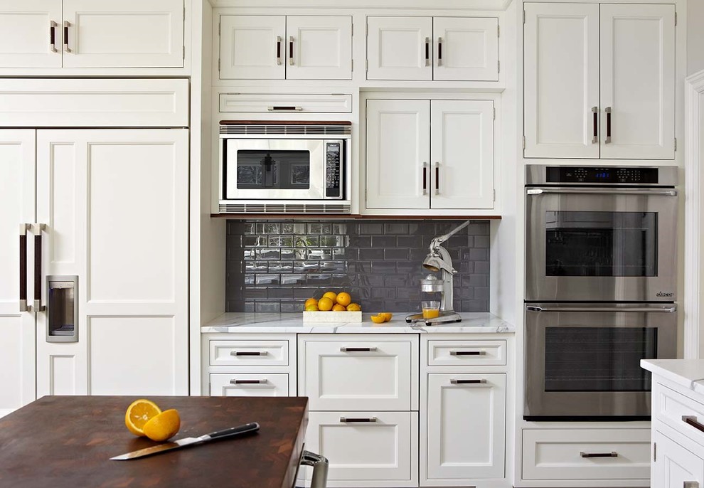 Classic kitchen in New York with beaded cabinets and white cabinets.