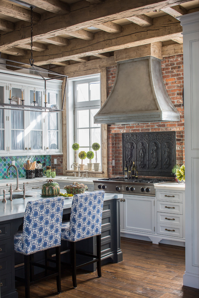 Cottage medium tone wood floor and brown floor kitchen photo in New York with shaker cabinets, white cabinets, green backsplash and an island