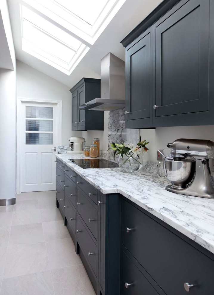 Photo of a medium sized contemporary kitchen/diner in Dublin with an integrated sink, shaker cabinets, grey cabinets, marble worktops, grey splashback, stone slab splashback, stainless steel appliances, terracotta flooring and an island.