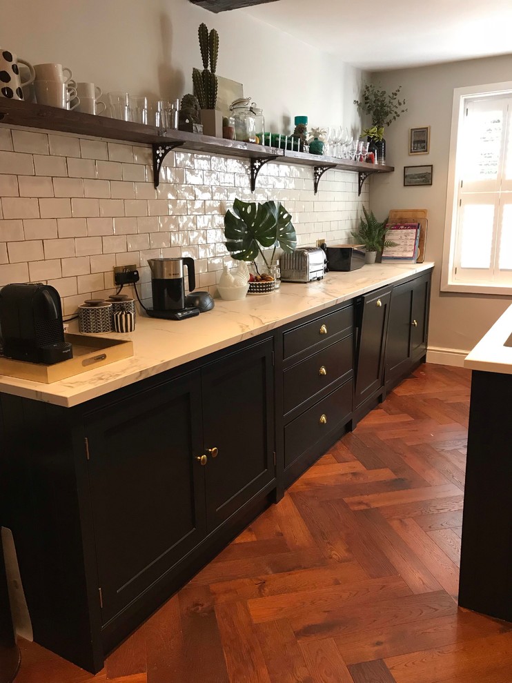 Dark blue kitchen with island and open plan shelving Traditional