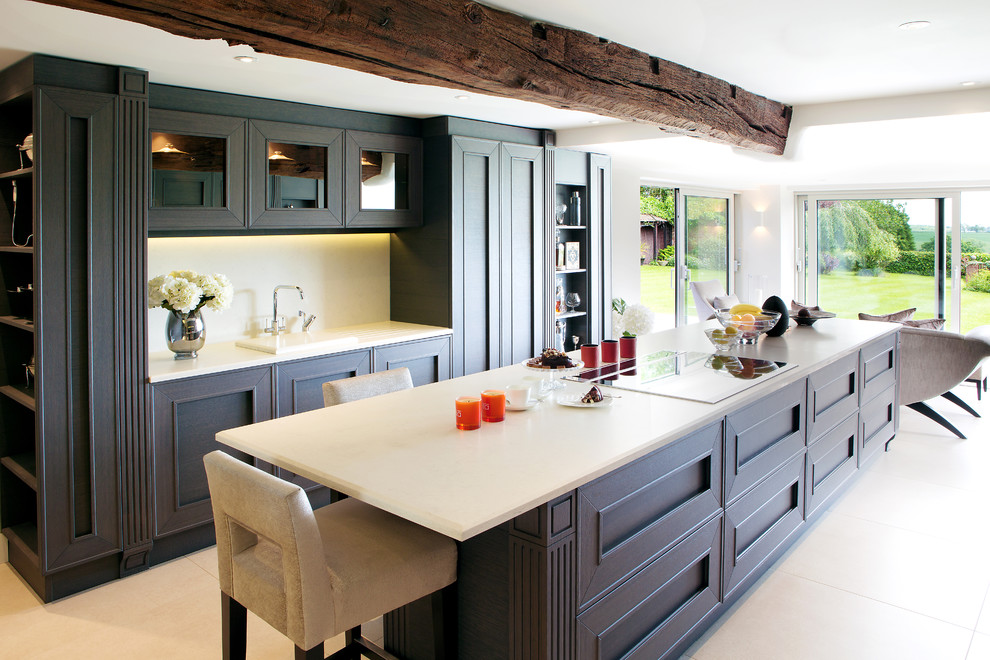 Large classic galley open plan kitchen in West Midlands with granite worktops, an island, a built-in sink, recessed-panel cabinets, brown cabinets and white splashback.