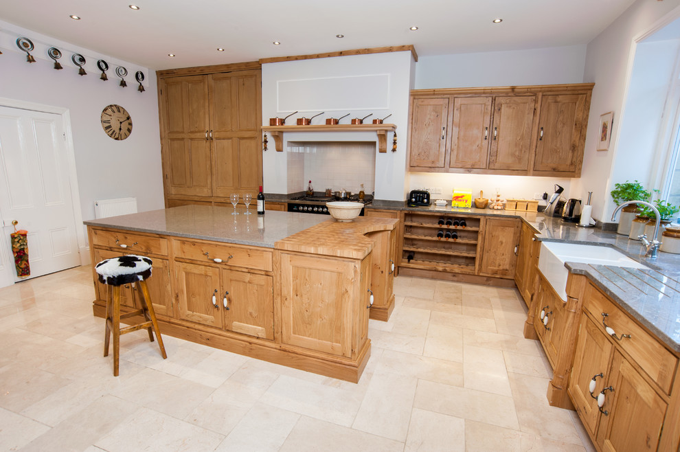 Photo of a large l-shaped kitchen in Other with a submerged sink, recessed-panel cabinets, medium wood cabinets, granite worktops, black appliances, ceramic flooring and an island.