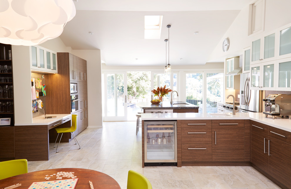 Inspiration for a contemporary galley eat-in kitchen remodel in San Francisco with an undermount sink, glass-front cabinets, white cabinets, multicolored backsplash and stainless steel appliances