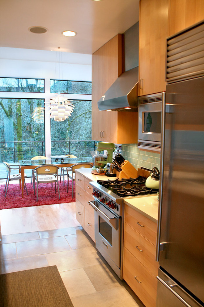 This is an example of a contemporary galley kitchen in Portland with stainless steel appliances.
