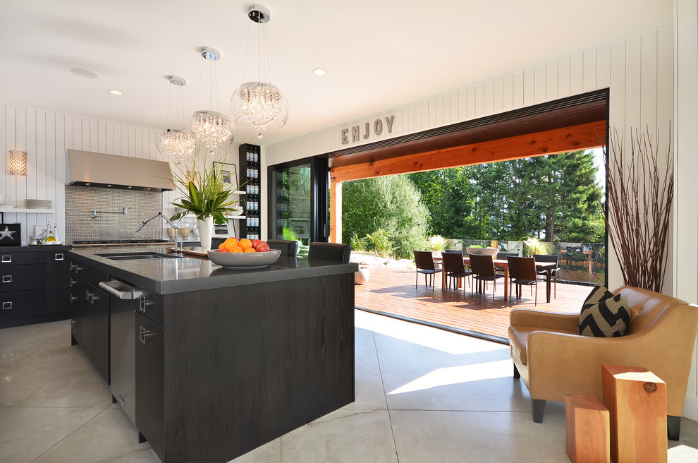 Example of a minimalist kitchen design in Vancouver with stainless steel appliances
