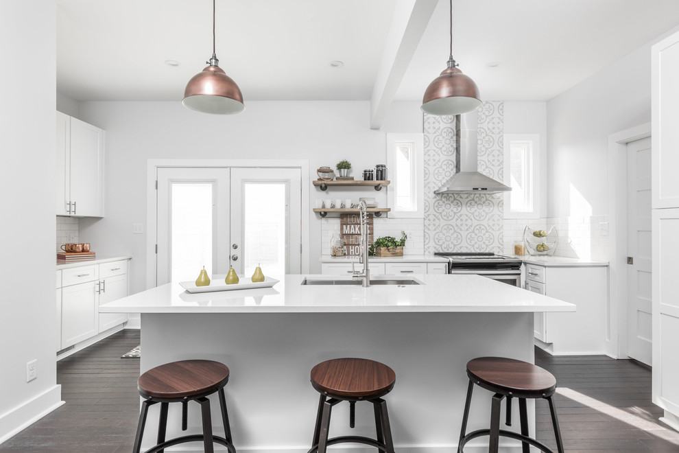 Inspiration for a large classic kitchen in Indianapolis with a submerged sink, white cabinets, granite worktops, stainless steel appliances, dark hardwood flooring, an island, brown floors, white worktops, shaker cabinets, white splashback and metro tiled splashback.