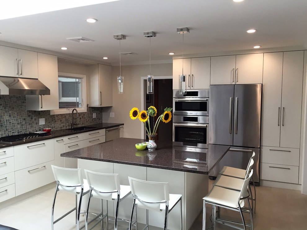 Kitchen - mid-sized transitional u-shaped porcelain tile and white floor kitchen idea in Philadelphia with a single-bowl sink, flat-panel cabinets, white cabinets, granite countertops, multicolored backsplash, mosaic tile backsplash, stainless steel appliances and an island