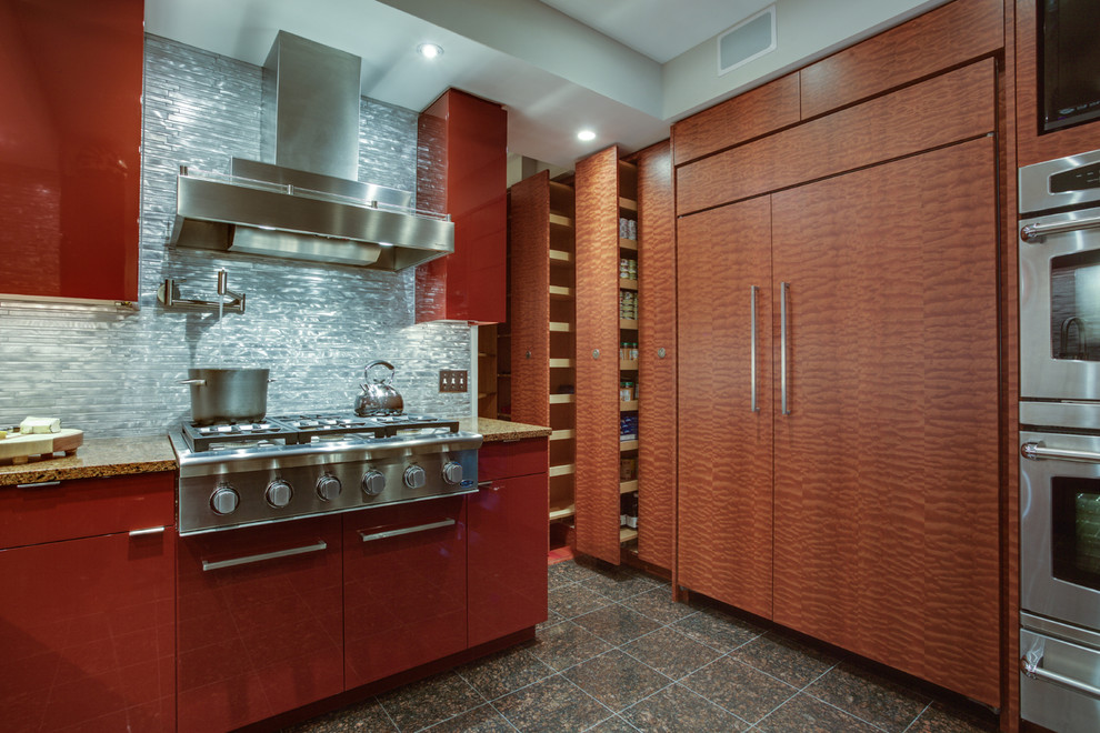 Small contemporary u-shaped enclosed kitchen in DC Metro with a submerged sink, flat-panel cabinets, red cabinets, engineered stone countertops, metallic splashback, metal splashback, stainless steel appliances, marble flooring and a breakfast bar.