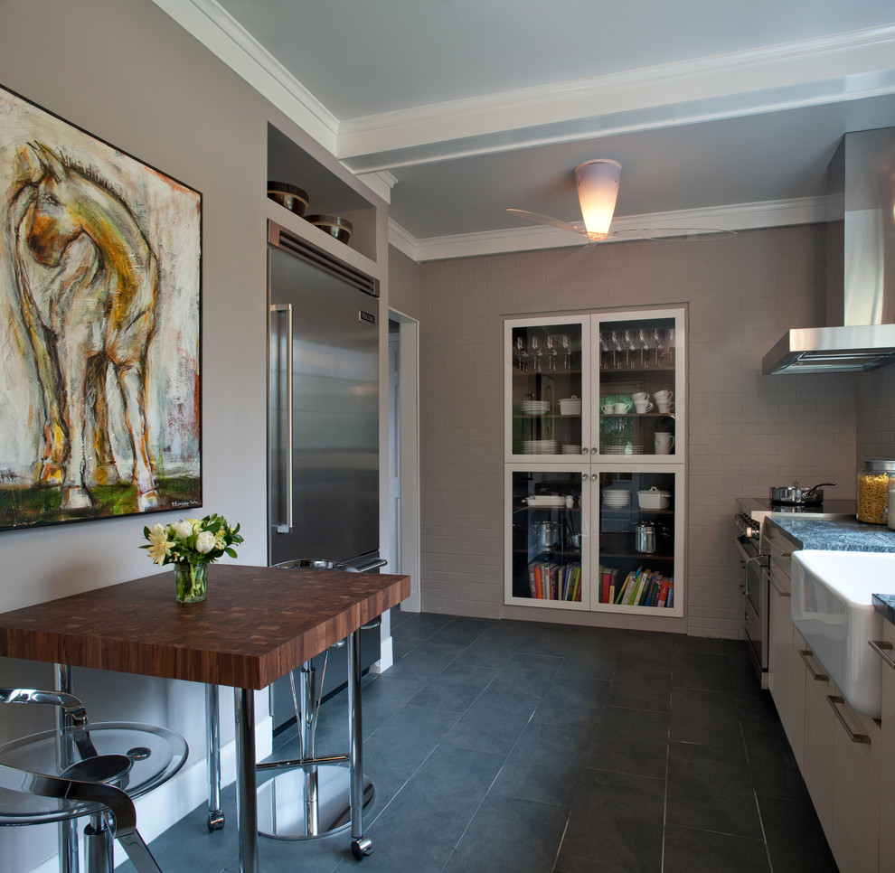 Photo of a contemporary kitchen in DC Metro with a belfast sink and stainless steel appliances.