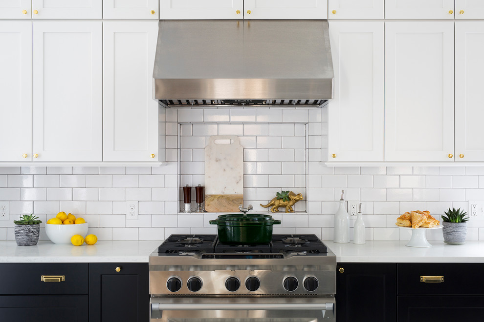 Eat-in kitchen - mid-sized transitional black floor eat-in kitchen idea in DC Metro with black cabinets, white backsplash, subway tile backsplash and stainless steel appliances