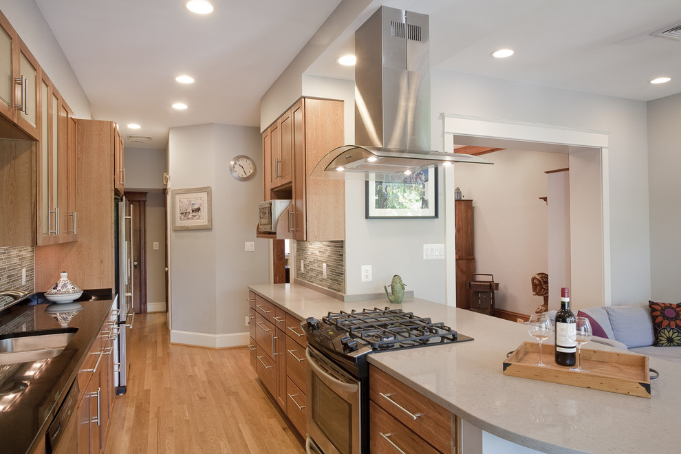 Example of a large trendy galley light wood floor and beige floor eat-in kitchen design in DC Metro with stainless steel appliances, a double-bowl sink, shaker cabinets, light wood cabinets, granite countertops and no island