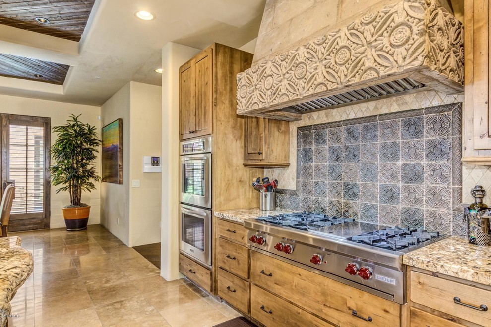 Example of a huge tuscan l-shaped terra-cotta tile and beige floor eat-in kitchen design in Phoenix with a farmhouse sink, light wood cabinets, granite countertops, multicolored backsplash, ceramic backsplash, stainless steel appliances, an island and beige countertops