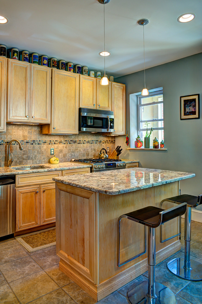 Small eclectic l-shaped ceramic tile enclosed kitchen photo in DC Metro with an undermount sink, recessed-panel cabinets, light wood cabinets, granite countertops, brown backsplash, stone tile backsplash, stainless steel appliances and an island