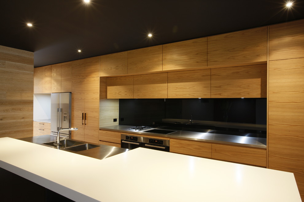Kitchen - contemporary kitchen idea in Melbourne with an integrated sink and stainless steel countertops
