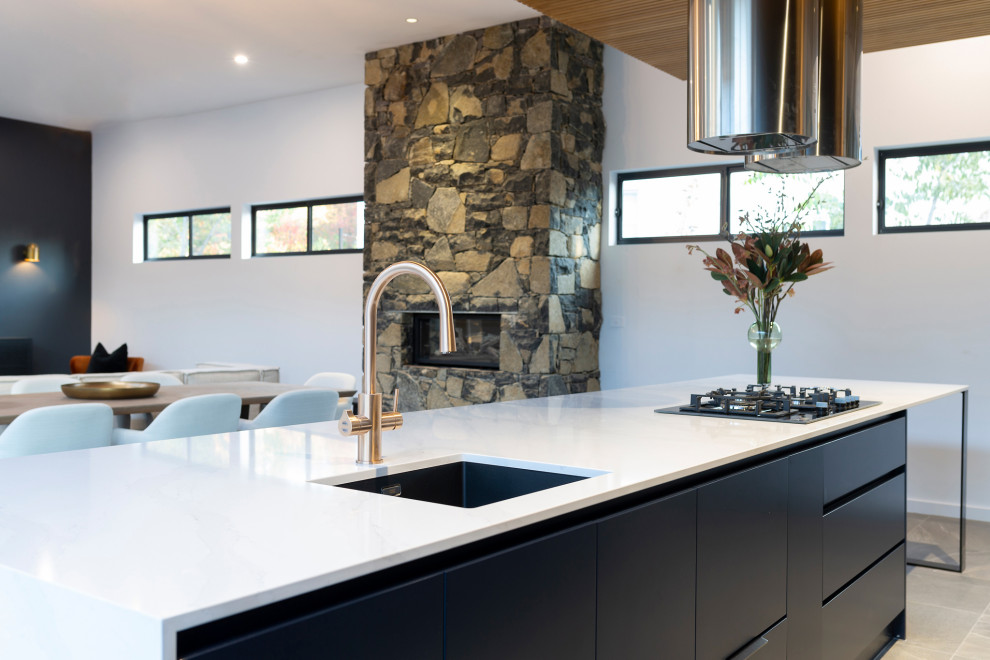 Inspiration for a large modern galley porcelain tile and gray floor open concept kitchen remodel in Canberra - Queanbeyan with an undermount sink, blue cabinets, quartz countertops, black appliances, an island and white countertops