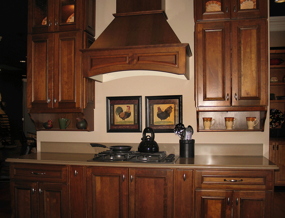 Example of a large classic u-shaped dark wood floor enclosed kitchen design in New York with an undermount sink, beaded inset cabinets, dark wood cabinets, quartz countertops, beige backsplash, black appliances and no island