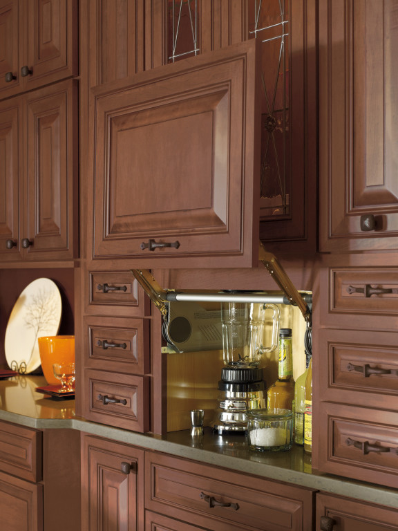 Design ideas for a traditional kitchen with raised-panel cabinets and medium wood cabinets.