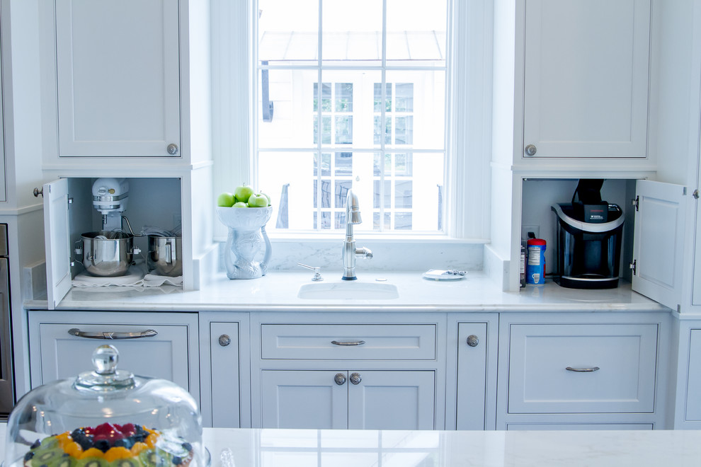 Exempel på ett klassiskt kök och matrum, med luckor med profilerade fronter, vita skåp, vitt stänkskydd och rostfria vitvaror