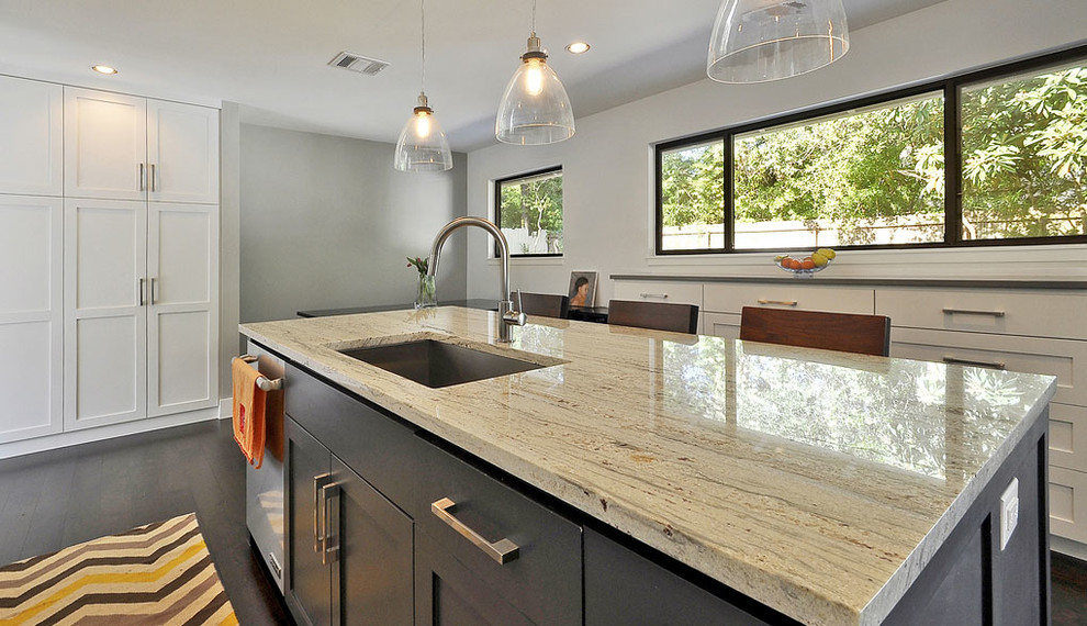 Trendy single-wall open concept kitchen photo in Austin with an undermount sink, recessed-panel cabinets, white cabinets, marble countertops, white backsplash, ceramic backsplash and stainless steel appliances