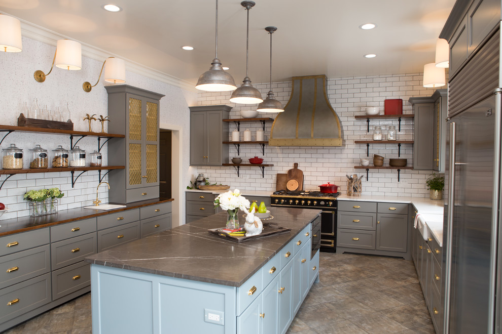 Enclosed kitchen - large transitional porcelain tile and gray floor enclosed kitchen idea in Chicago with a farmhouse sink, shaker cabinets, gray cabinets, limestone countertops, white backsplash, subway tile backsplash, black appliances, an island and gray countertops