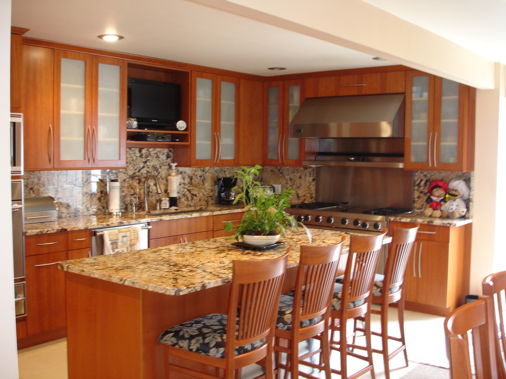 Mid-sized trendy l-shaped eat-in kitchen photo in New York with an undermount sink, flat-panel cabinets, medium tone wood cabinets, granite countertops, stone slab backsplash, stainless steel appliances and an island