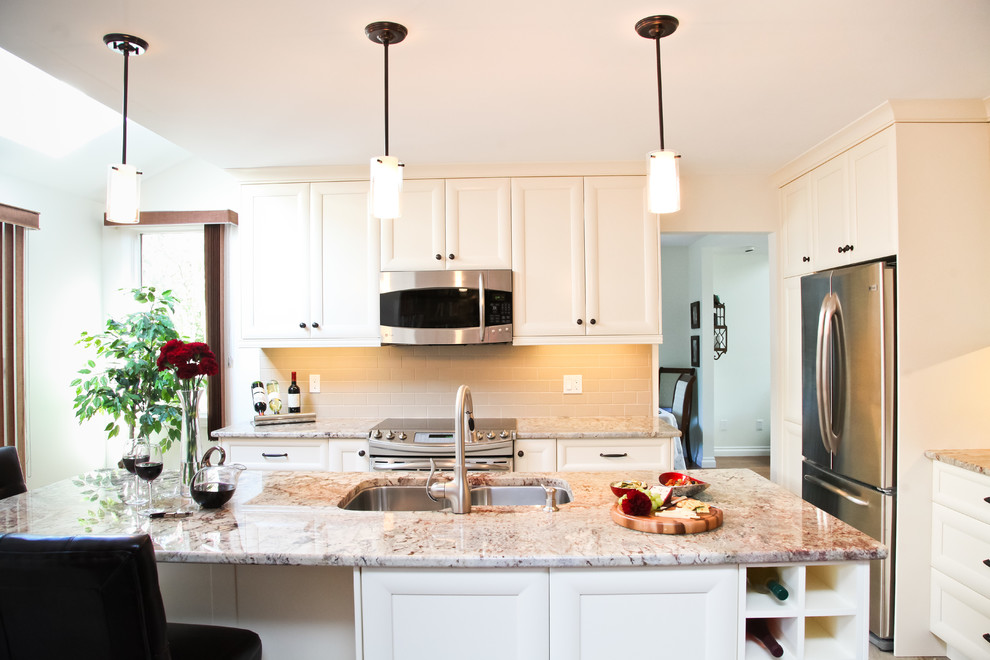 Example of a mid-sized transitional l-shaped porcelain tile eat-in kitchen design in Toronto with a double-bowl sink, recessed-panel cabinets, white cabinets, granite countertops, beige backsplash, subway tile backsplash, stainless steel appliances and an island