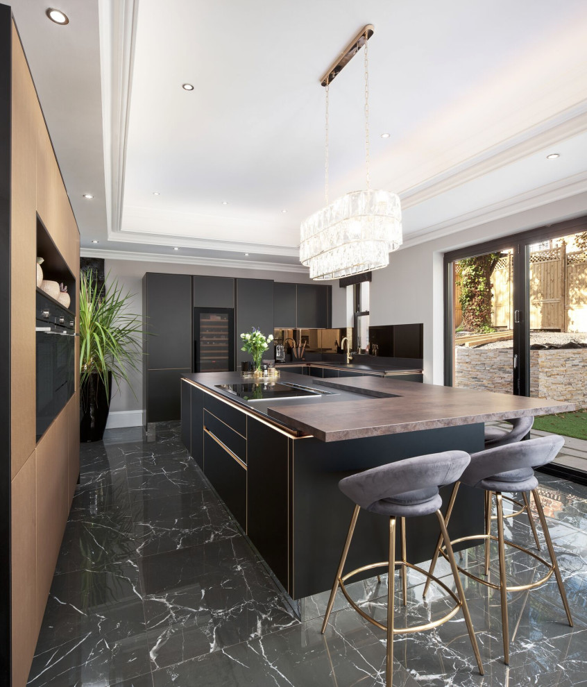 This is an example of an expansive contemporary u-shaped kitchen in Miami with a submerged sink, flat-panel cabinets, black cabinets, wood worktops, integrated appliances, porcelain flooring, an island, black floors and brown worktops.