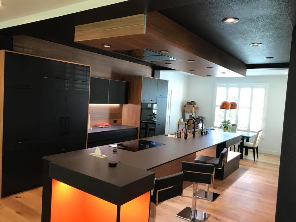 Immagine di una grande cucina moderna con lavello sottopiano, top in vetro e top marrone