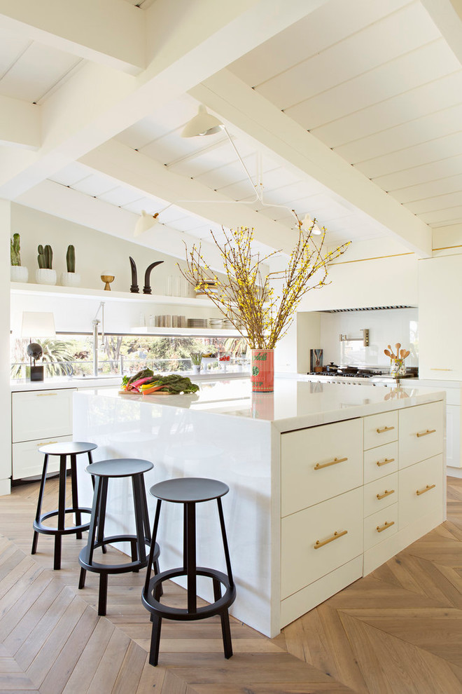 Nautical kitchen in San Diego with a submerged sink, flat-panel cabinets, white cabinets, window splashback, light hardwood flooring, an island and beige floors.