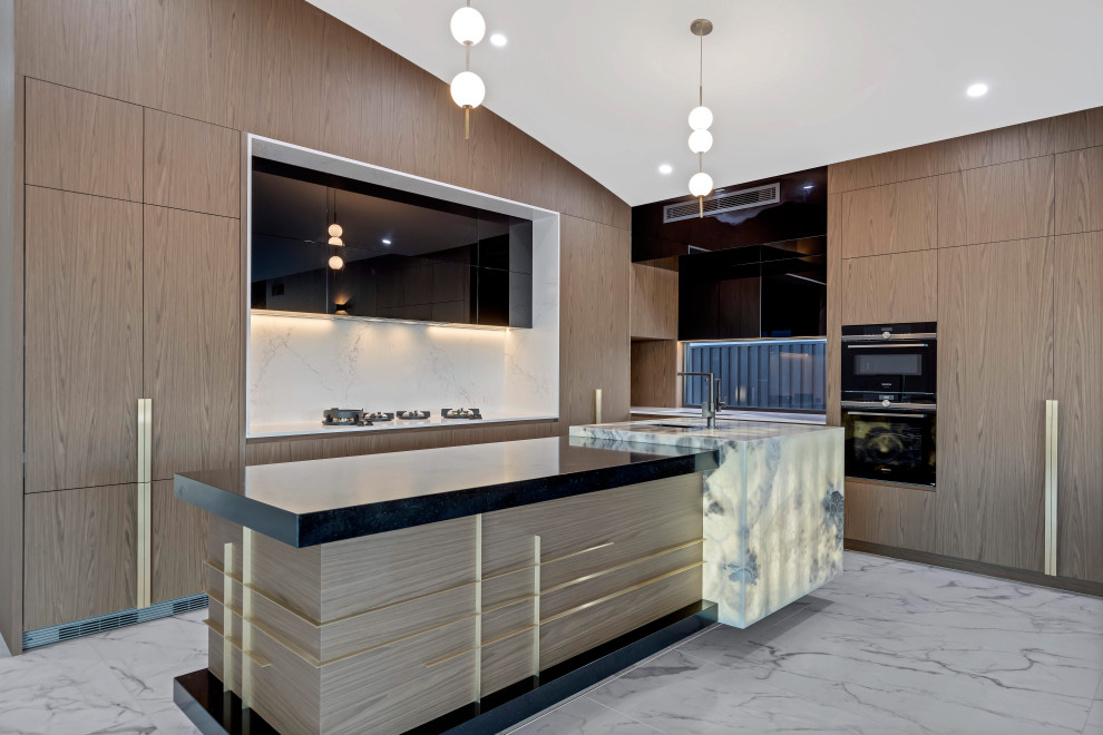 Inspiration for a contemporary l-shaped kitchen in Sunshine Coast with flat-panel cabinets, medium wood cabinets, white splashback, stone slab splashback, black appliances, an island, white floors, white worktops and a vaulted ceiling.