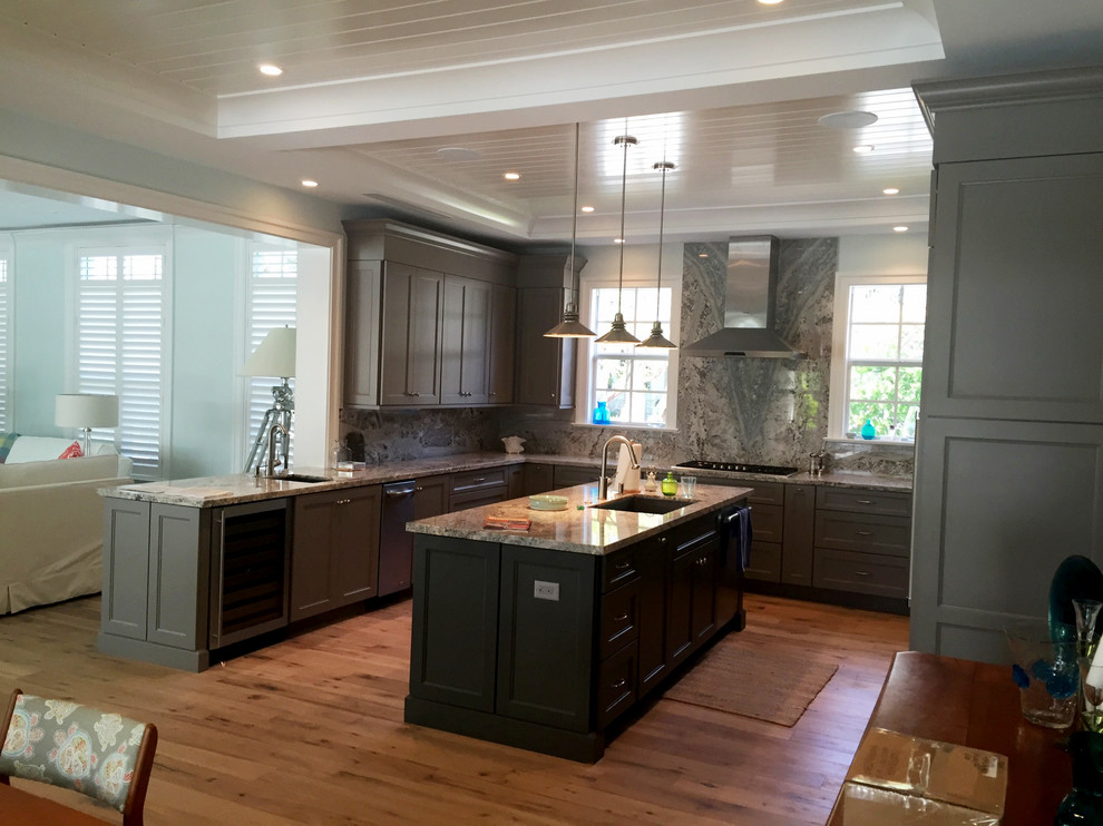 Large transitional u-shaped light wood floor eat-in kitchen photo in Miami with an undermount sink, shaker cabinets, gray cabinets, granite countertops, white backsplash, stone slab backsplash, stainless steel appliances and an island