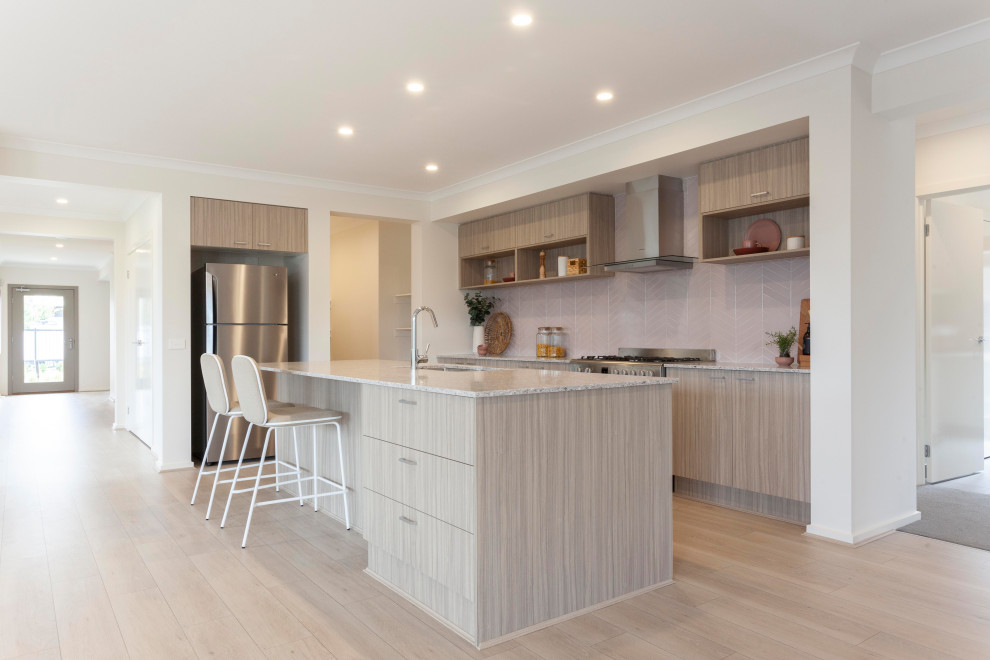 Inspiration for a contemporary l-shaped light wood floor and beige floor eat-in kitchen remodel in Melbourne with a drop-in sink, quartz countertops, beige backsplash, ceramic backsplash, stainless steel appliances, an island, white countertops, flat-panel cabinets and gray cabinets