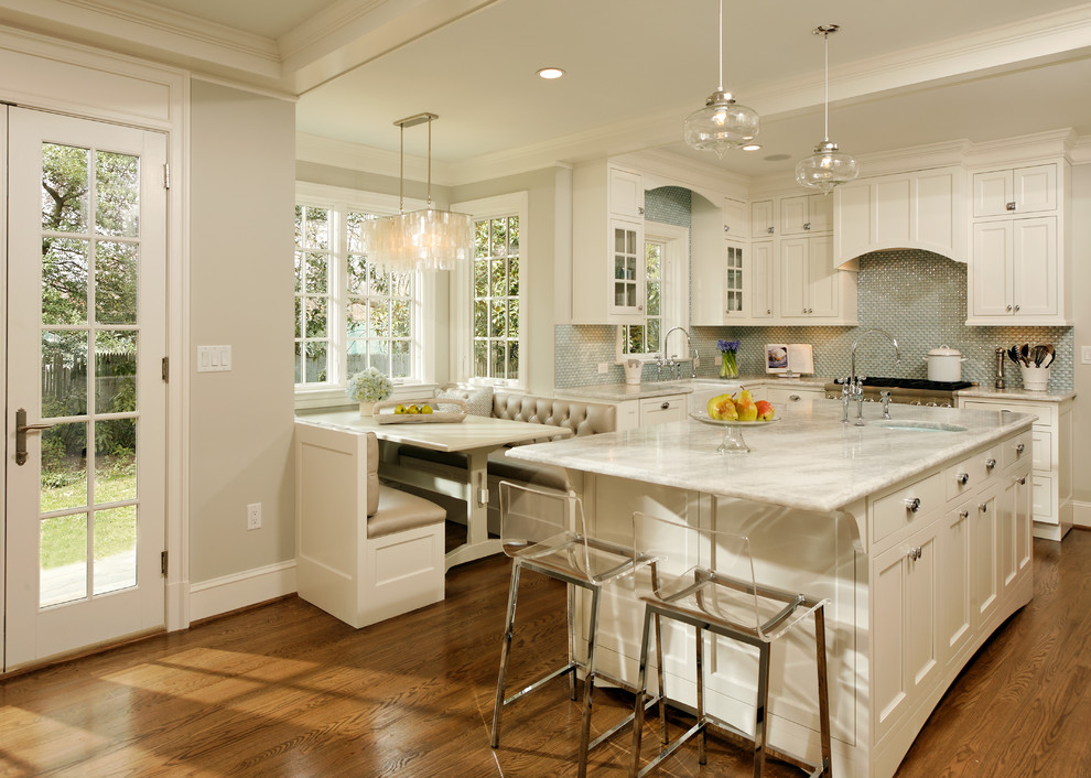 Elegant eat-in kitchen photo in DC Metro with a farmhouse sink, shaker cabinets, white cabinets, quartzite countertops, blue backsplash, glass tile backsplash and stainless steel appliances
