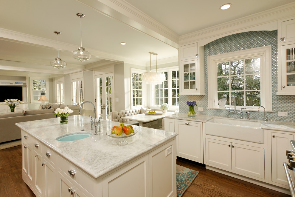 Example of a classic open concept kitchen design in DC Metro with a farmhouse sink, blue backsplash, white cabinets, quartzite countertops and recessed-panel cabinets