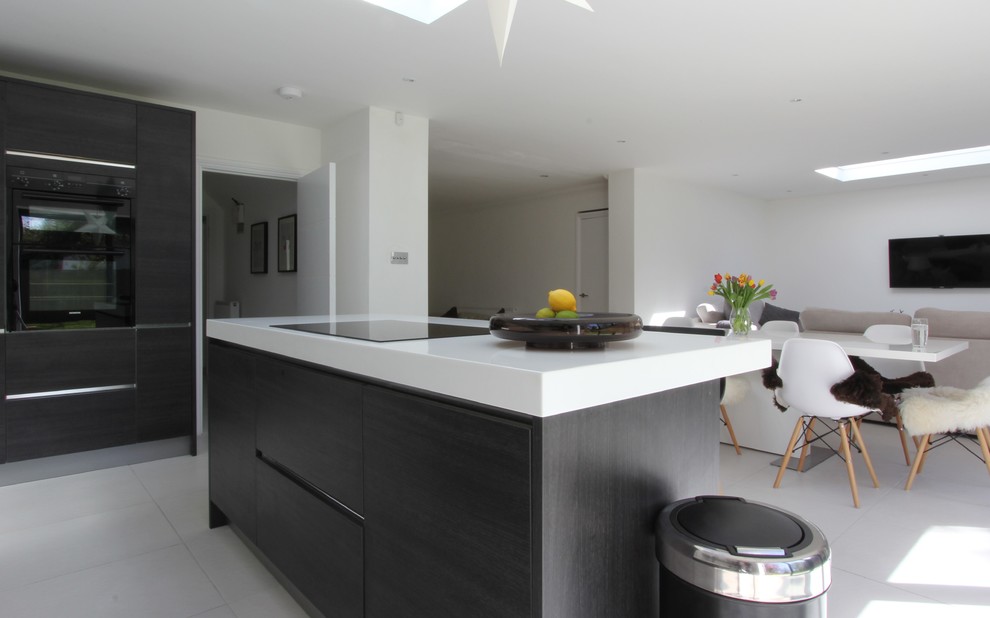 Photo of an expansive contemporary kitchen in Sussex with an integrated sink, porcelain flooring and an island.