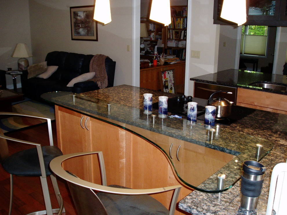 Inspiration for a timeless l-shaped eat-in kitchen remodel in Other with an undermount sink, raised-panel cabinets, light wood cabinets and glass countertops