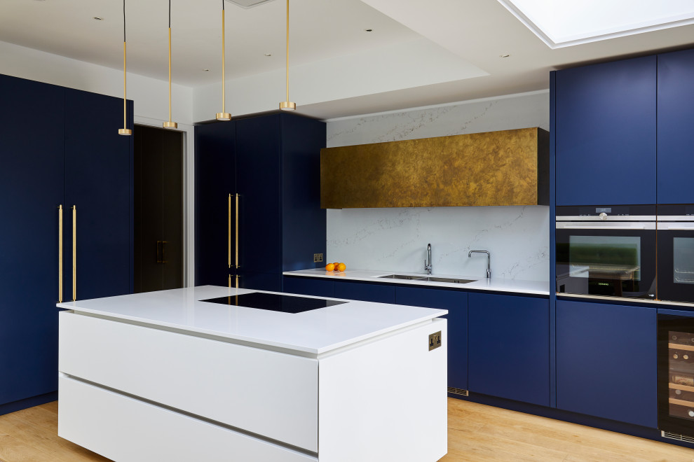 Photo of a contemporary l-shaped open plan kitchen in Other with blue cabinets, marble worktops, white splashback, marble splashback and white worktops.
