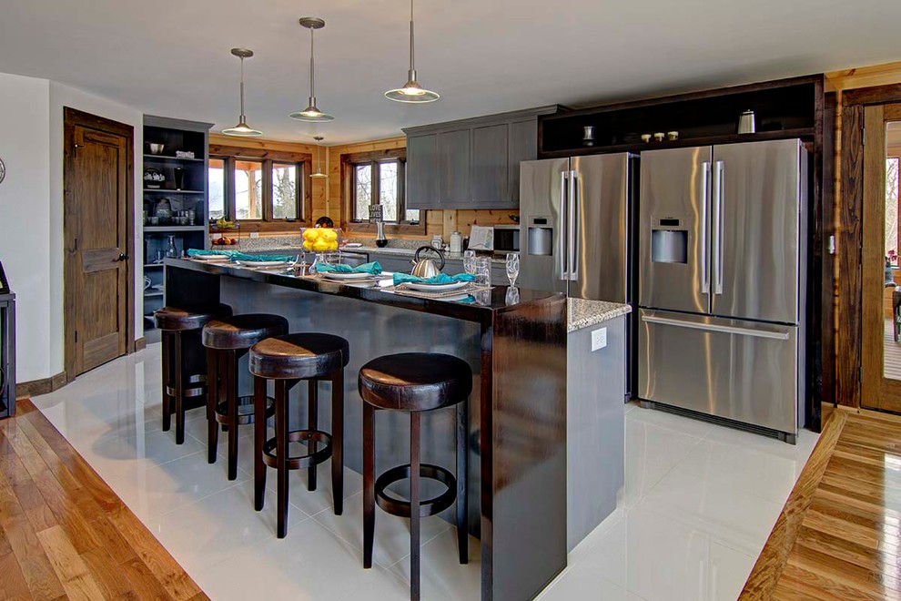 Example of a mountain style kitchen design in Charlotte with an island