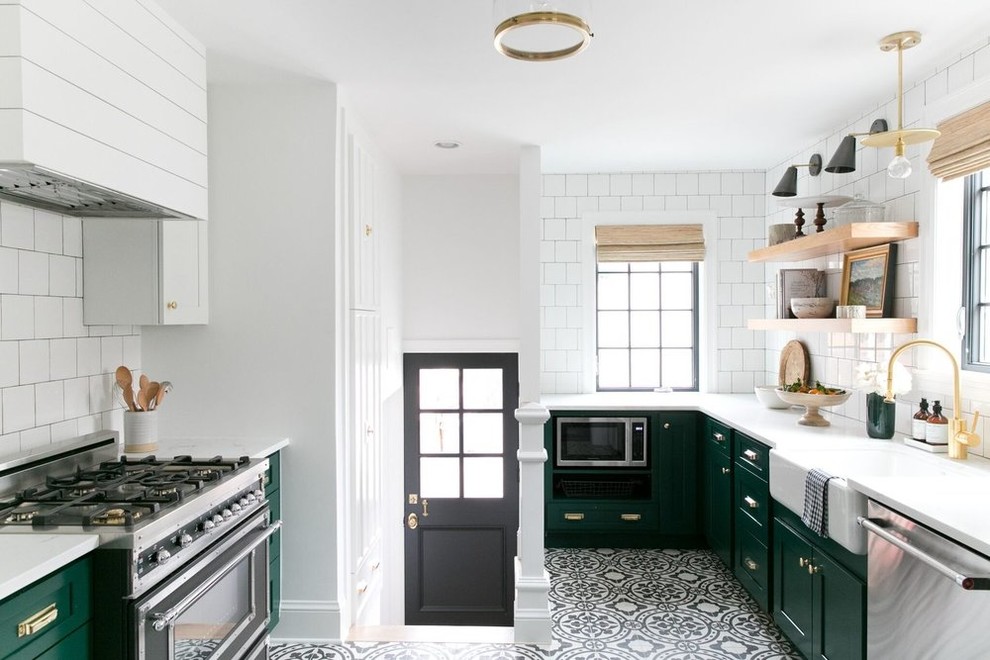 Exempel på ett klassiskt kök, med en rustik diskho, skåp i shakerstil, vitt stänkskydd, stänkskydd i tunnelbanekakel, svarta vitvaror, flerfärgat golv och cementgolv
