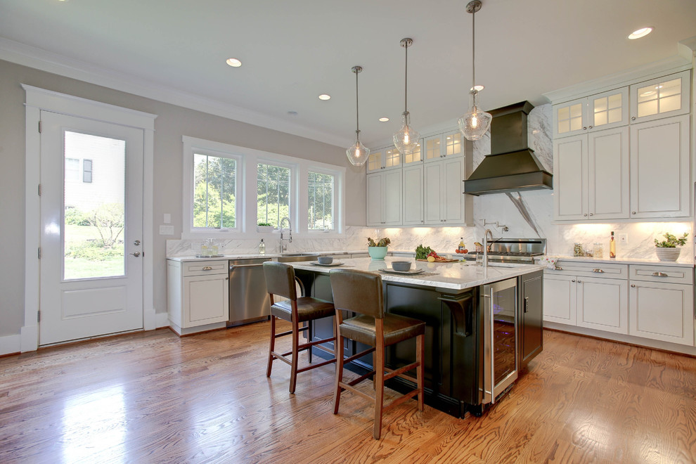 Eat-in kitchen - mid-sized craftsman u-shaped light wood floor eat-in kitchen idea in DC Metro with an undermount sink, glass-front cabinets, white cabinets, marble countertops, gray backsplash, stone slab backsplash, stainless steel appliances and an island