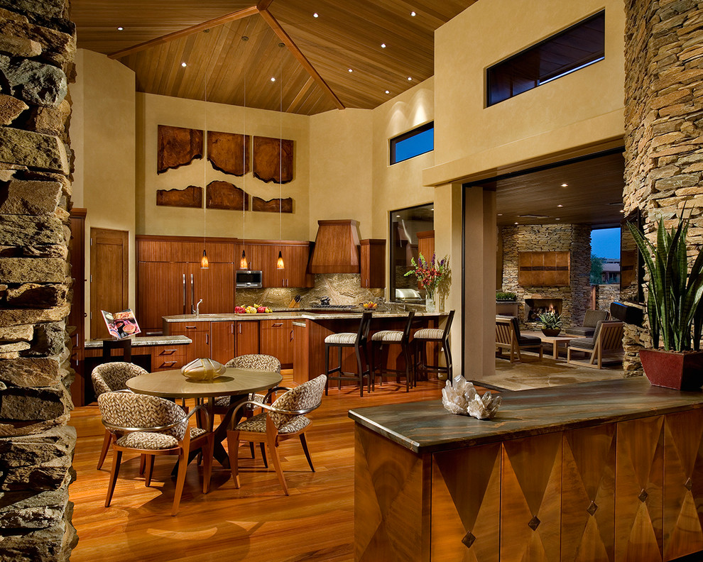 Inspiration for a large contemporary u-shaped medium tone wood floor kitchen remodel in Phoenix with a double-bowl sink, flat-panel cabinets, medium tone wood cabinets, granite countertops, stone slab backsplash, paneled appliances and an island