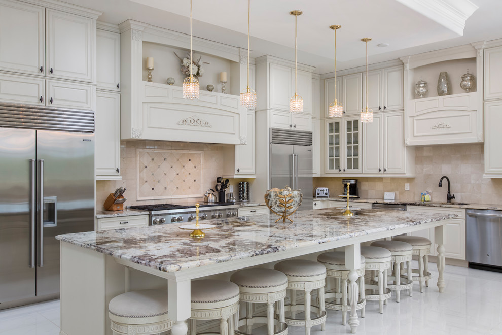 Design ideas for a traditional kitchen in Orlando with a submerged sink, raised-panel cabinets, white cabinets, stainless steel appliances, an island, white floors and beige splashback.