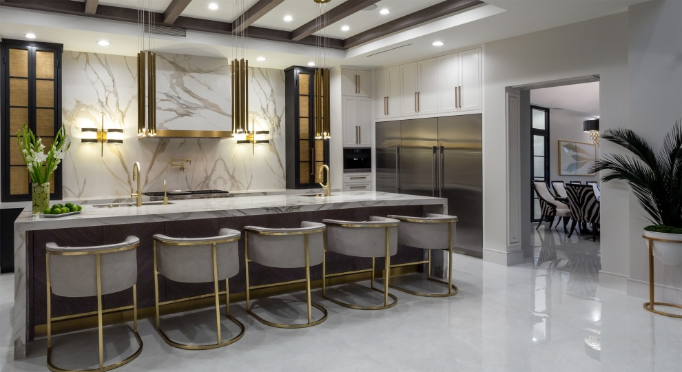 Example of a huge transitional single-wall porcelain tile and white floor open concept kitchen design with an undermount sink, raised-panel cabinets, black cabinets, quartz countertops, white backsplash, marble backsplash, stainless steel appliances, an island and white countertops
