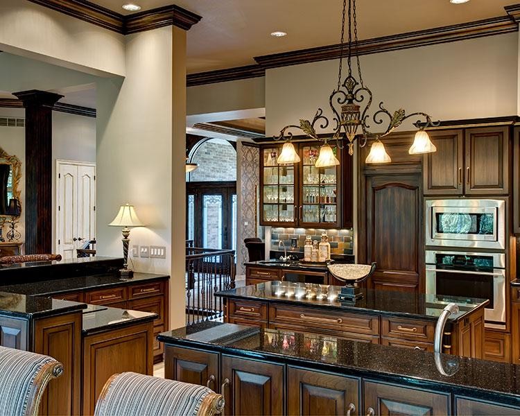 Eat-in kitchen - large traditional u-shaped porcelain tile eat-in kitchen idea in Kansas City with a double-bowl sink, beaded inset cabinets, dark wood cabinets, granite countertops, multicolored backsplash, stone tile backsplash, stainless steel appliances and an island