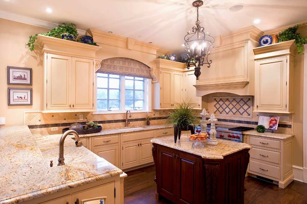 Large traditional grey and cream u-shaped kitchen/diner in Chicago with granite worktops, beige cabinets, stainless steel appliances, dark hardwood flooring, an island, a submerged sink, raised-panel cabinets, multi-coloured splashback, porcelain splashback, brown floors and beige worktops.