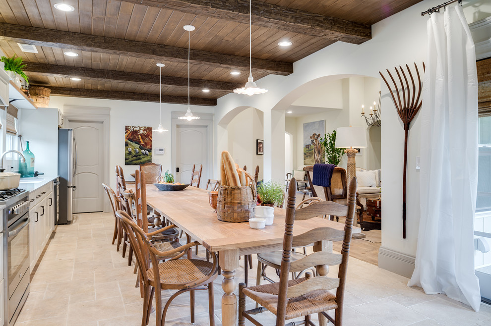 Photo of an expansive farmhouse single-wall kitchen/diner in DC Metro with a submerged sink, raised-panel cabinets, white cabinets, concrete worktops, stainless steel appliances, travertine flooring, no island and beige floors.