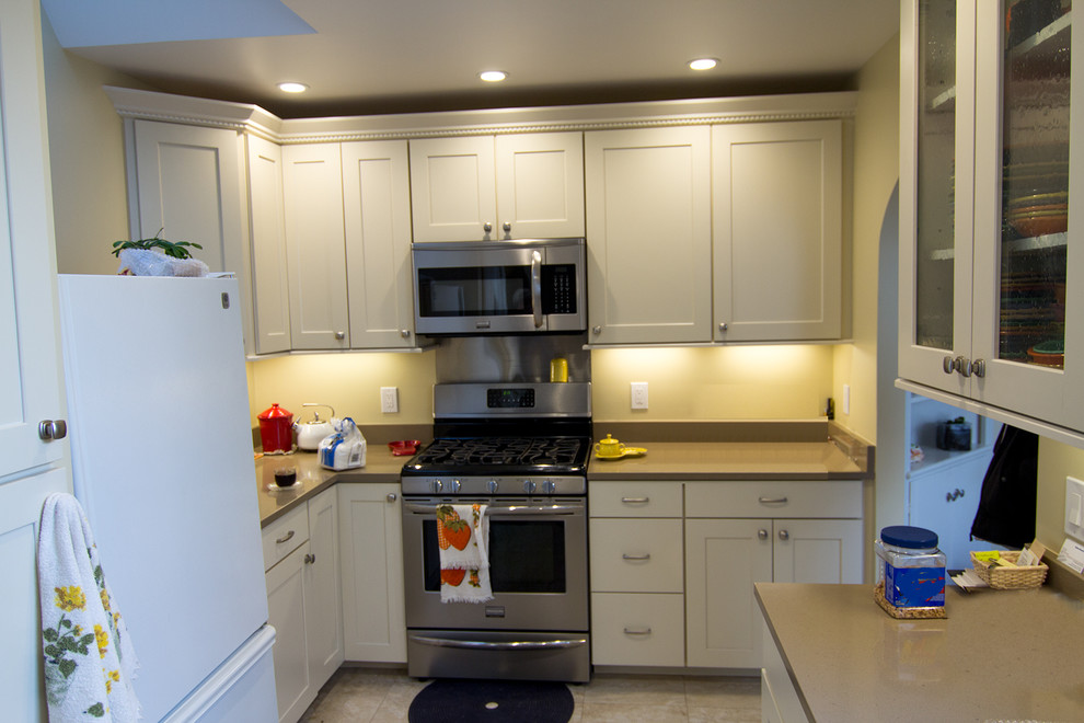 Inspiration for a transitional u-shaped eat-in kitchen remodel in San Francisco with an undermount sink, recessed-panel cabinets and white cabinets