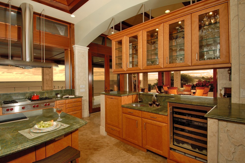 Example of a beach style eat-in kitchen design in Hawaii with glass-front cabinets, stainless steel appliances, granite countertops, green backsplash and green countertops